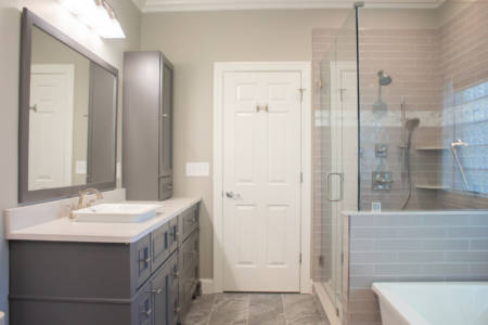 Franklin Tennessee bathroom Remodel grey vanity, white quartz countertop, walkin shower, white tub,  decorative mirrors, grey tile