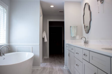 Franklin Tennessee bathroom Remodel grey double vanity, white quartz countertop, white tub, decorative mirrors, grey tile