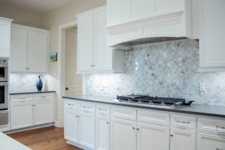 Franklin Tennessee Kitchen Remodel white cabinets, marble tile backsplash, quartz grey countertops, wood floors