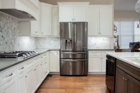 Franklin Tennessee Kitchen Remodel white cabinets, marble tile backsplash, quartz grey countertops, wood floors