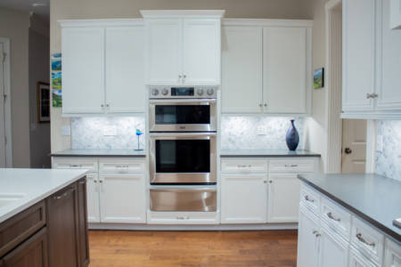 Franklin Tennessee Kitchen Remodel white cabinets, marble tile backsplash, quartz grey countertops, wood floors