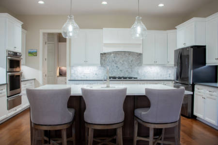 Franklin Tennessee Kitchen Remodel white cabinets, marble tile backsplash, quartz grey countertops, wood floors